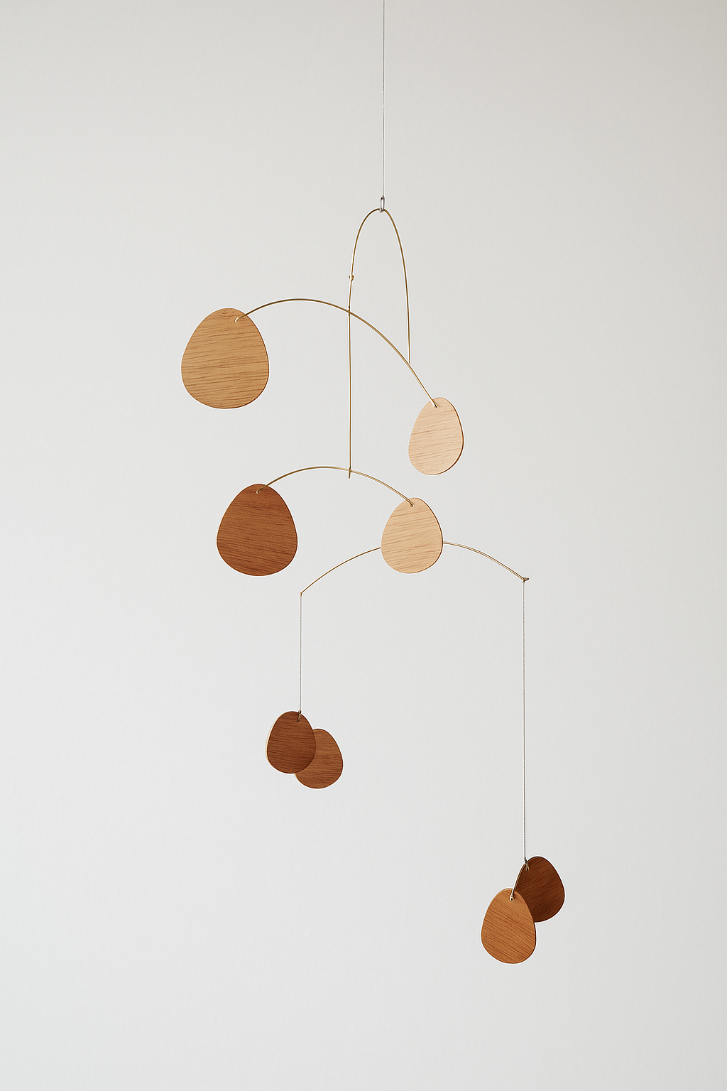 Wooden mobile with hanging circles on a white background